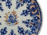 blue and white plate with blue flowers and a bird on it