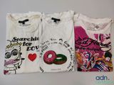 trois t-shirts aux motifs différents posés sur une table
