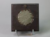 a picture of a small wooden clock on a stand