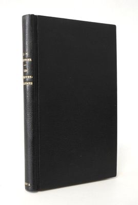 un livre noir orné de lettres dorées, posé sur une surface blanche