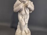 a statue of a boy holding a bird in his hands