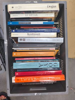 a stack of books sitting on top of a metal rack