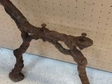 a metal object that looks like a bird on a branch