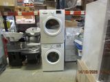 a stack of washers and dryers in a store