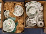 two boxes of tea cups and saucers on the floor