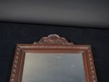 a mirror that is sitting on a black surface