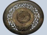 a metal plate with a decorative design on it