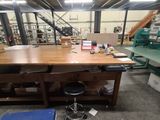a workbench in the middle of a room with a lot of shelves