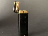 a close up of a lighter on a table with a gray background
