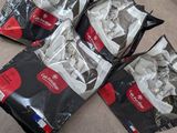 four bags of food sitting on the floor next to each other