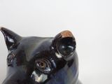 a black cat statue sitting on top of a white table