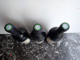four bottles of beer are lined up on a counter top