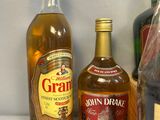 several bottles of alcohol are lined up on a shelf