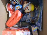 a cardboard box filled with toys and other items