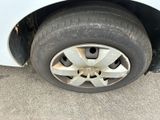 a close up of a tire on the side of a white car