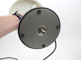 a person that is holding a lamp in their hand