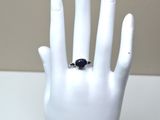 a hand with a ring on it that is on display