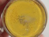 a person holding a glass of orange juice in their hand