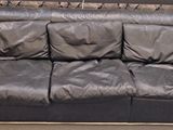a black leather couch that is on display in a store
