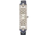 une montre Art déco sertie de diamants et de saphirs, signée Cartier