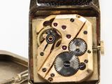 a watch that is sitting next to a pocket watch