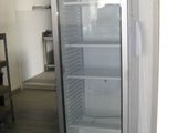 an image of a glass door refrigerator in a room