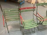 two green chairs sitting next to each other in a room