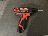 a close up of a cordless drill on a black surface