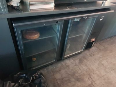 a microwave oven sitting on top of a metal cabinet