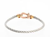 a close up of a cable bracelet with a clasp on it