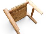 a chair made out of wood and wicker on a white background