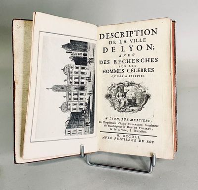 an open book with a drawing of a building on it