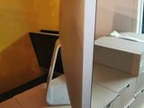 a computer monitor sitting on top of a desk