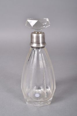 a clear glass bottle with a silver stopper on it
