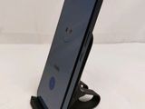 a close up of a cell phone on a stand on a table
