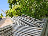 a pile of metal pipes sitting on the side of the road