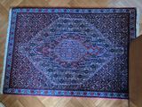 an oriental rug on the floor next to a pair of shoes