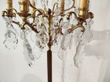 a large crystal chandelier on a wooden stand