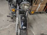 a motorcycle that is parked in a garage with boxes on the back