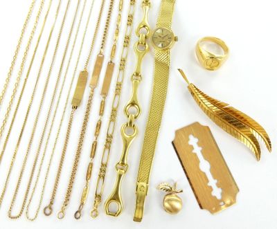 a lot of gold jewelry on a white surface