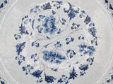 a blue and white plate with a floral design on it
