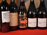 several bottles of wine are lined up on a table