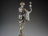 a bronze statue of a man holding a bird on a marble base