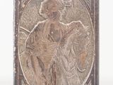 an antique silver plate with a picture of a man on a horse