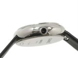 a close up of a watch on a white surface