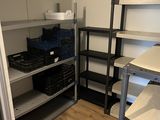 a room with shelves, shelves, and bins in it