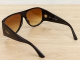 sunglasses on a wooden table with a white wall in the background