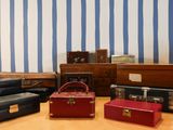 several pieces of luggage sitting on top of a wooden table