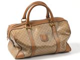 le sac marron et beige est posé sur une surface blanche