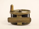 a small brass object on a white surface